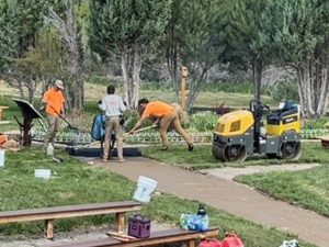 The asphalt is wheeled to site and quickly leveled off. The pathway is now six feet wide safer for walkers and wheelchairs.