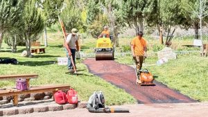 Workers applied the earth colored aggregate.